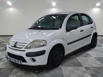 a picture of a small white car parked on a checkered floor