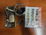 a jar of coins sitting on top of a table next to a wallet