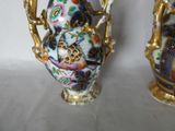 two vases sitting side by side on a table