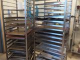 many trays of food that are on a metal rack