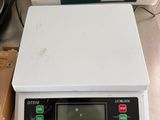 an image of a scale with a roll of paper on top of it