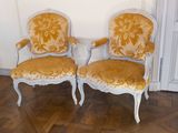 two chairs sitting next to each other on a wooden floor