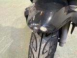 a close up of a motorcycle that is parked on the street