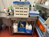 a metal table with a bunch of cleaning supplies on it