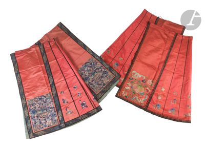 two pieces of red silk with black trims and flowers on them