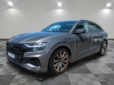 a grey audi qx parked on a checkered floor