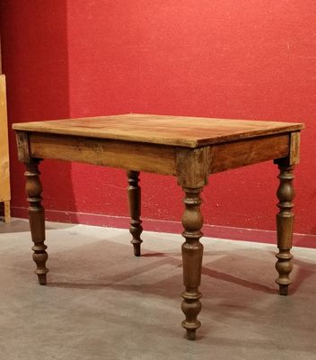 a small table with a wooden top on a carpeted floor
