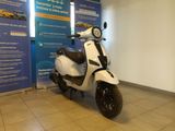 a scooter that is parked in front of a wall