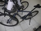 three bikes that are sitting on the floor in a room