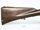 an old rifle with a wooden barrel on a white background