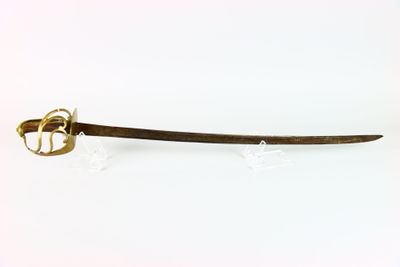 a sword that is sitting on a white surface