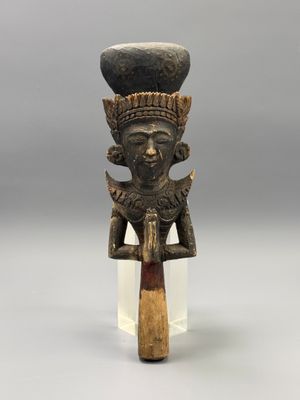 a close up of a statue of a person with a hat on top of it