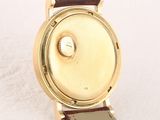 a close up of a watch on a white surface