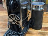 an image of a coffee machine and a cup on a table