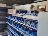 a room with a lot of shelves and bins in it