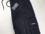 a black cargo pants with a tag on the side of it