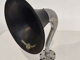 a black and silver horn on a tripod stand