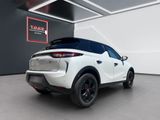 the rear end of a white suv parked in a garage