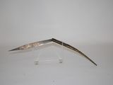 a small metal object with a long blade on it