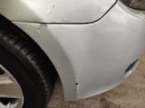 a close up of a car ' s front bumper and fender