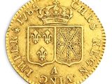 a close up of a gold coin with a crown on it