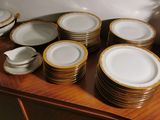 a lot of plates and cups on a wooden table