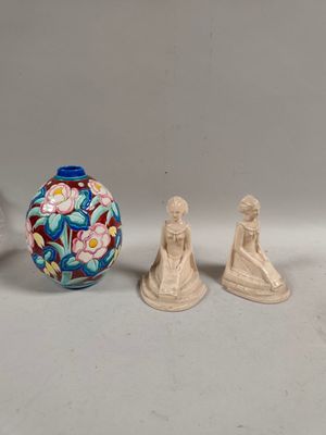 three figurines sitting next to each other on a table