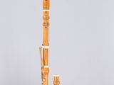 a close up of a gold and black musical instrument on a white surface