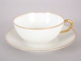 a cup and saucer on a saucer on a table