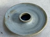 a blue plate with a hole in the middle of it