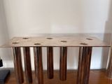 a wooden table with four legs on a wooden floor
