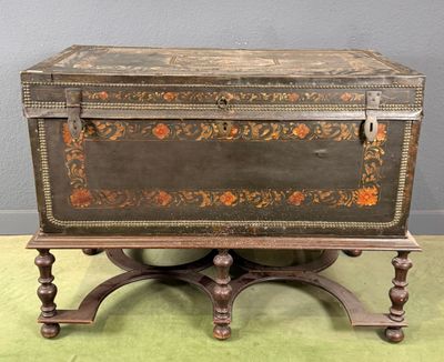 an old trunk on a stand on the floor