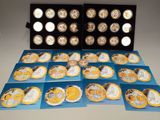 several different types of gold and silver coins in a display case