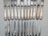 a lot of silverware on a table with a knife and fork