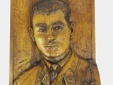 a picture of a wooden plaque with a picture of a man on it