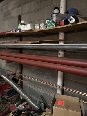 a man standing in a room with a lot of pipes