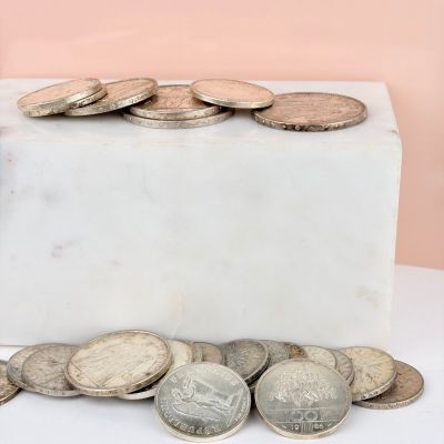 a white marble block with a bunch of coins on it