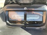 a close up of a car ' s rear bumper with a warning sticker on it