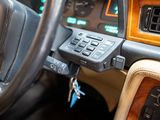 a car dashboard with a remote control and a steering wheel