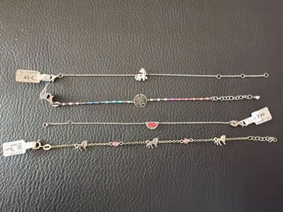 five different bracelets with charms and charms on them