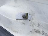 a close up of a piece of metal on the side of a building