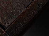 a close up of a piece of wood with writing on it