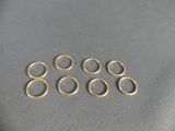a close up of a bunch of gold rings on a table