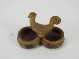 two bowls with a bird on them on a table