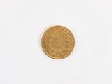 a close up of a gold coin on a white surface