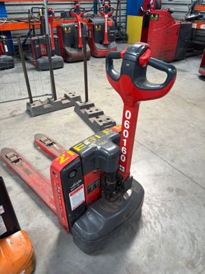 a forklift in a warehouse with lots of other equipment