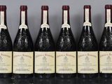 six bottles of wine are lined up in a row on a table