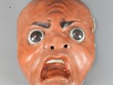 a clay mask with a face that looks like a man ' s face
