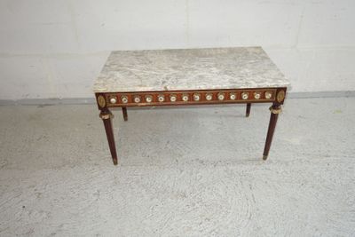 a small table with a marble top in a room
