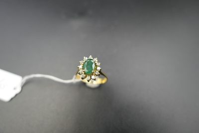 a close up of a ring with a green stone on it
